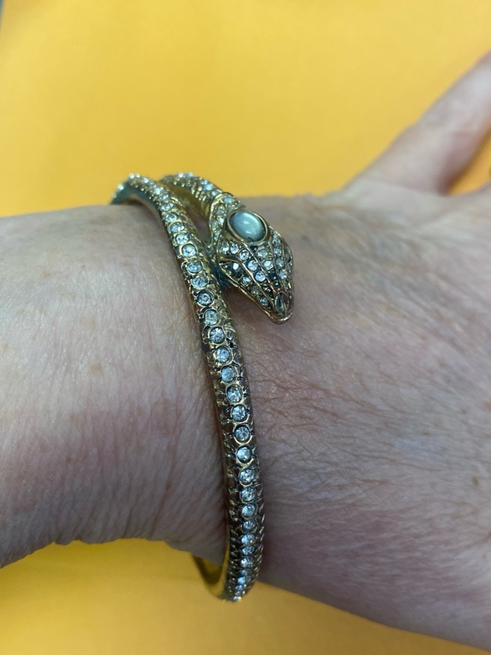 Gold tone and rhinestone snake bracelet
